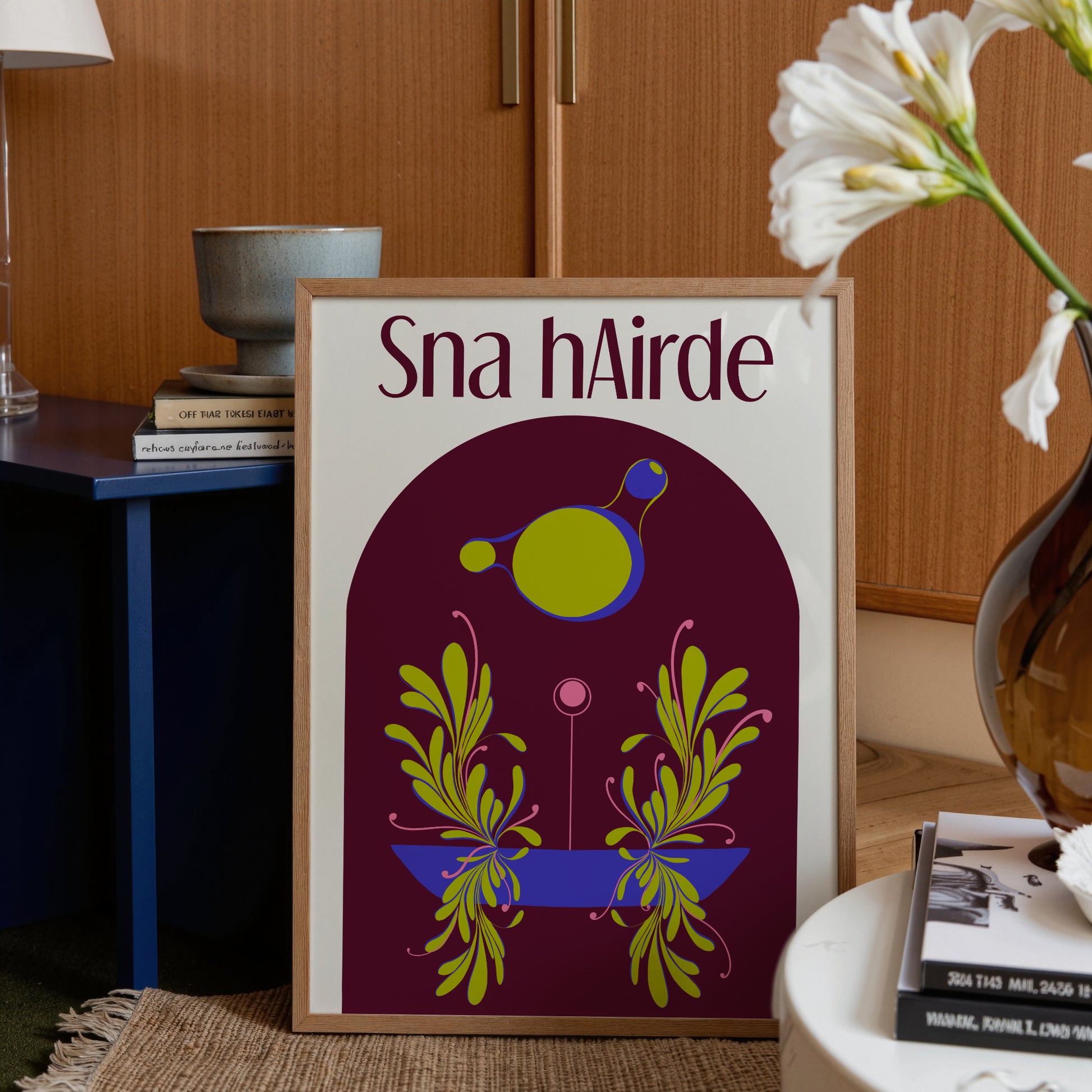 Framed artwork with 'Sna hAirdre' text and colorful design in a home setting.