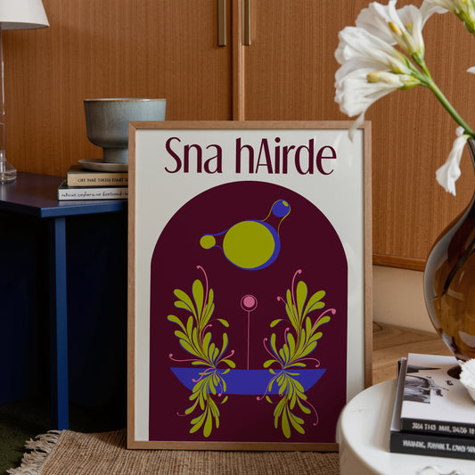 Framed artwork with 'Sna hAirdre' text and colorful design in a home setting.