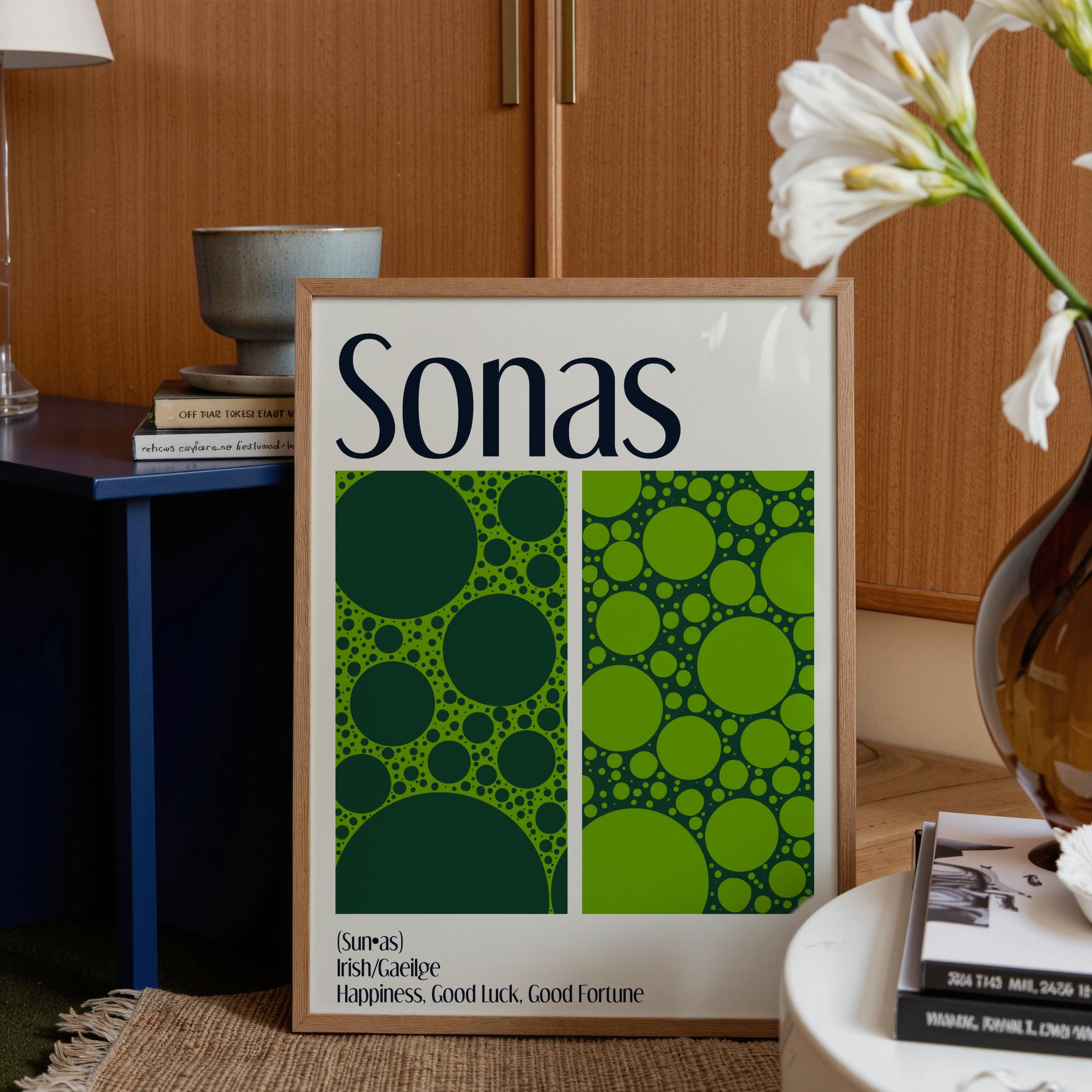 Framed poster with 'Sonas' design and text in a home setting